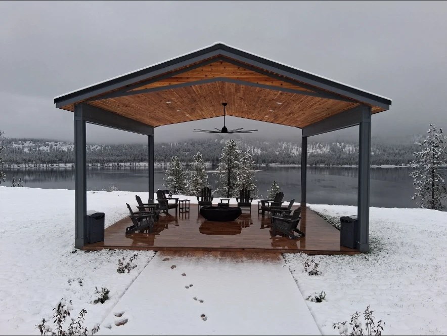 Lakeside covered pavilion with a standing seam metal roof overlooking the water